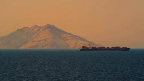 A container ship in the Mediterranean sea with the island of Montecrist Stock Footage 112006448
