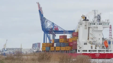 Container ship motion along port buildings and cranes 4k Stock Footage 46210739