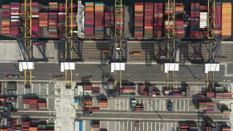 Container ship navigating into a busy industrial port Video stock 287070143