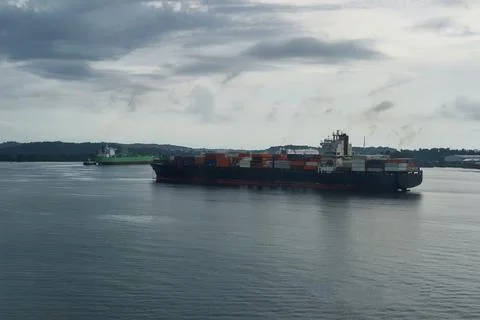 Container Ship Navigating Busy Maritime Route Near Major Port Stock Photos