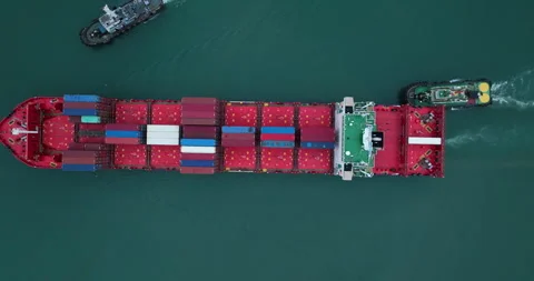 Container Ship Navigating Open Ocean Assisted By Tugboats Extreme Wide Shot Video stock 331287978