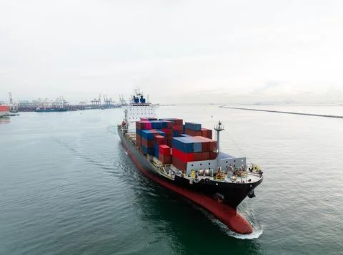 Container Ship Navigating Through Harbor Shipping Lane On Calm Day Wide Shot 库存照片