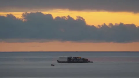 Container ship on the ocean viewed from a distane in 4k 스톡 동영상 279943498