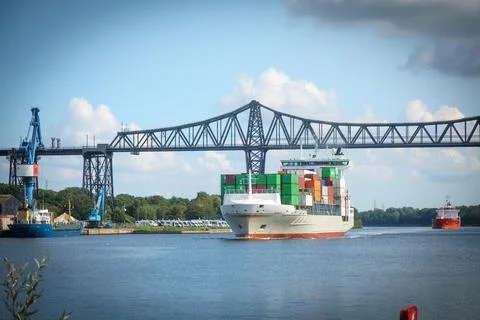 A container ship passes under the Rendsburg high bridge Stock Photos