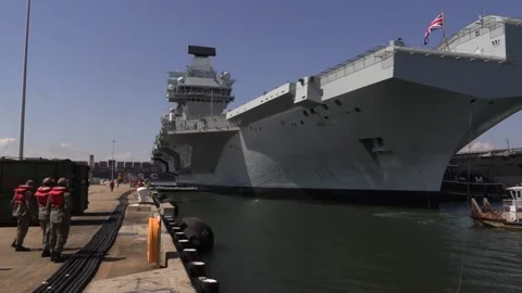 Container ship passing behind Royal Navy... | Stock Video | Pond5