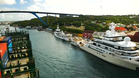 Container ship passing explorer super yachts Game Changer and Voyager Stock Footage 243515034