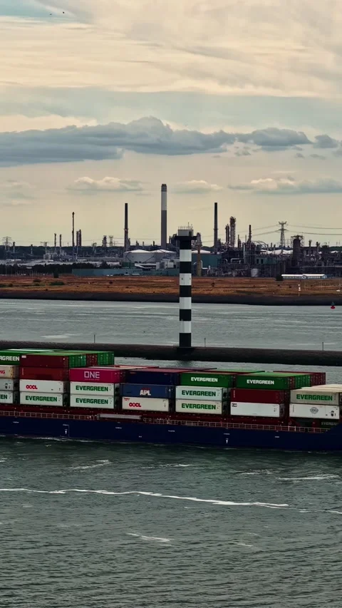 Container Ship Passing Lighthouse at Industrial Port of IJmuiden, North Holland Stock Footage 345500327