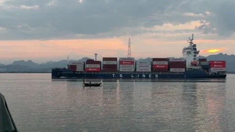 Container Ship Passing by Small Fishing Boat at Sunrise. Stock-Footage 344111015