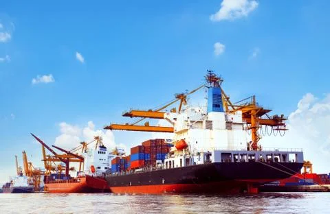 Container ship in port cargo dock with piers crane tool use for import export Fotos Stock