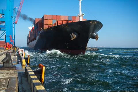 Container ship in port at container terminal. Ships of container ships stand  Stock Photos