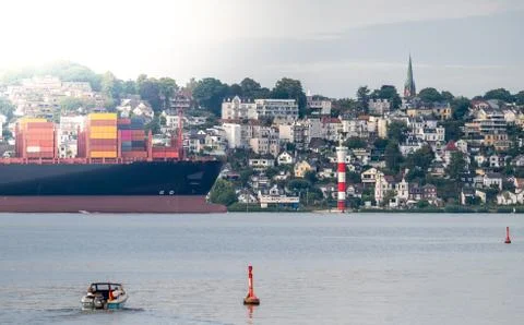 Container ship on the river Elbe in front of the district Blankenese in Hambu Stock Photos