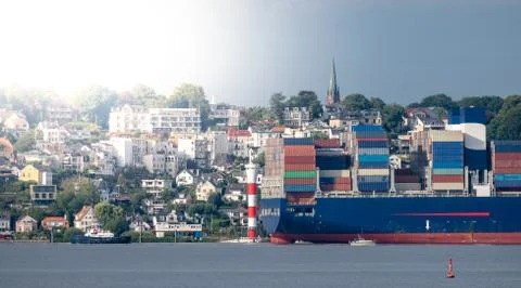 Container ship on the river Elbe in front of the district Blankenese in Hambu Stock Photos