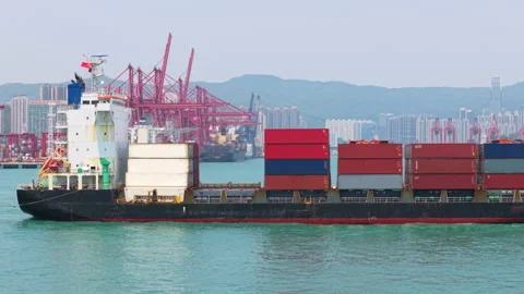 Container Ship Sailing Across Hong Kong Harbor, Showcasing Port Infrastructure Stock Footage 317311765
