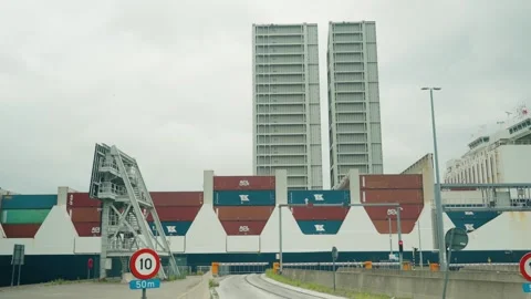 Container ship slowly passing Kieldrechtsluis with raised bridge and safety Stock Footage 341909675
