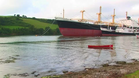 Container ship with small red boat Stock Footage 61575609