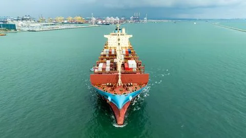 Container Ship Transporting Cargo Approaching Port Terminal In Harbor Chann.. Stock-Fotos