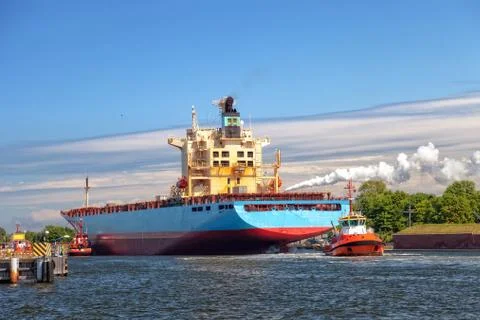 Container ship with tugboat Stock Photos