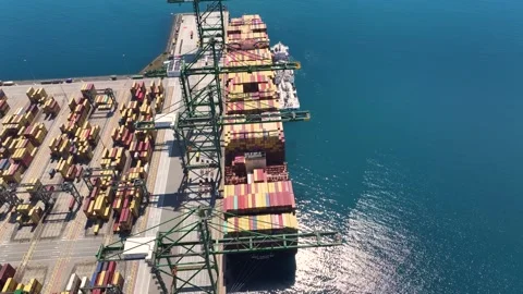 Container ship unloading cargo at port showing logistics operations Stock Footage 334974670