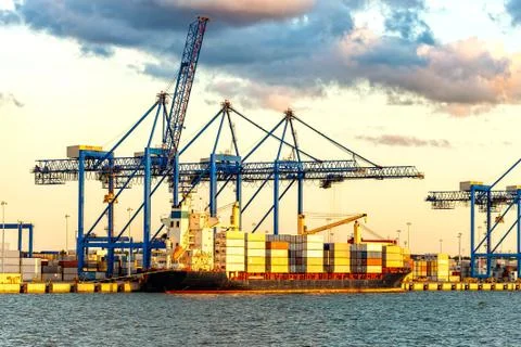 Container ship unloading at a dock Stock Photos