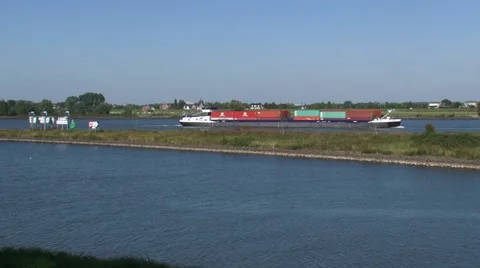 Container ship upstream at the confluence of the rivers Maas and Waal Stock Footage 55603406