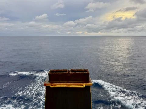 Container Shoes On Cargo Ship Deck With Ocean Wake In Background Stock Photos