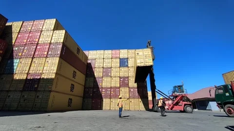 Container-side loader hoisting a shipping container Stock Footage 312022189