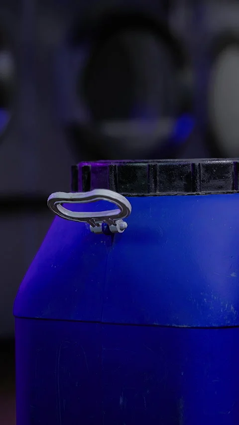 Container sits on a surface with a dark background and soft light in a room Stock Footage 331678090