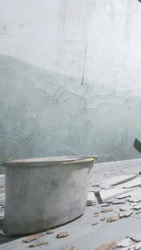 Container sits on a wooden table with peeling paint in a worn space Stock Footage 337970395
