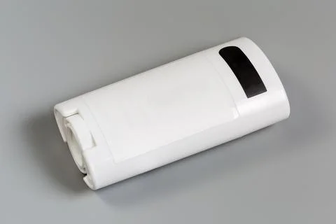 Container of solid deodorant on a gray background Stock Photos