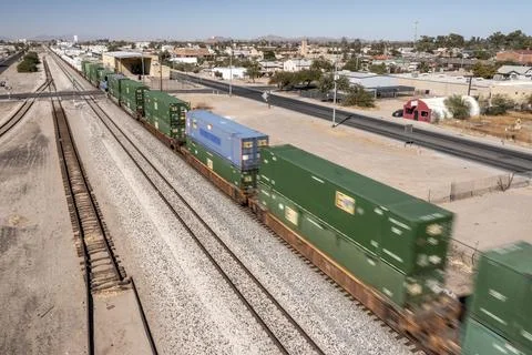 Container stack train moving in southwestern small town Foto stock