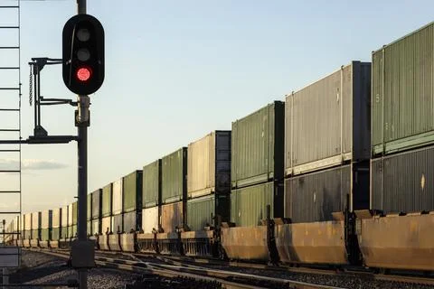 A container stack train passing signals into the distance Stock Photos