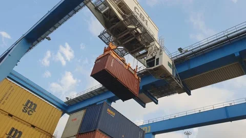 Container stacking crane lifts 20 feet cargo container to truck 4k Stock Footage 134501727