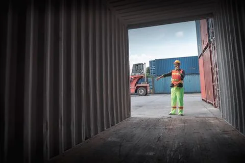 Container Supervisor Control Import/Export While Inspecting Containers Box in Stock Photos