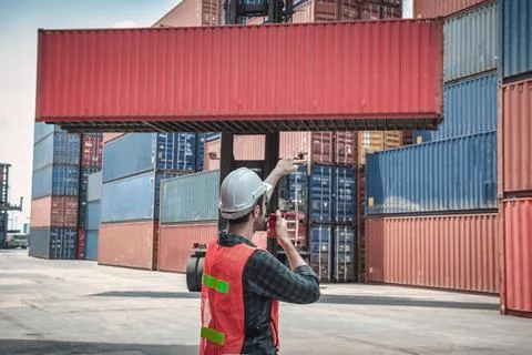 Container Supervisor Control Import/Export While Inspecting Containers Box in Stock Photos