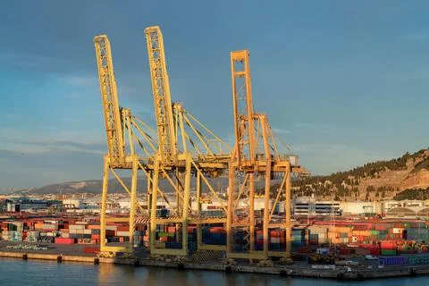 Container terminal gantry cranes and shipping containers at sunset, Barcelo.. Stock Illustration