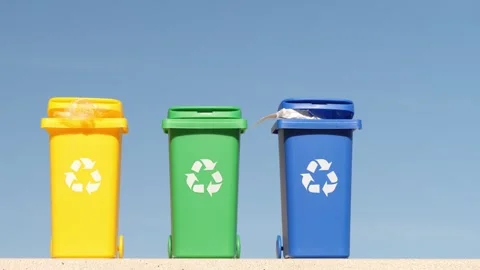 Container trash bin for recycling on blue sky background. Yellow, green, blue 스톡 동영상 263898397