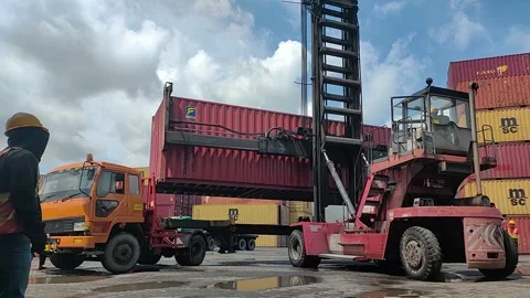 Container truck-large red container is being lifted from a truck by a forklift Stock Footage 299621615