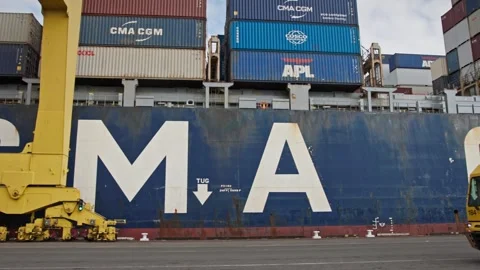 Container trucks transporting tank containers at busy shipping dock terminal. Stock Footage 334250460
