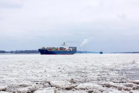 Container Vessel Breaking Through Thick Ice on the Frozen Elbe River, Hamburg Stock Photos
