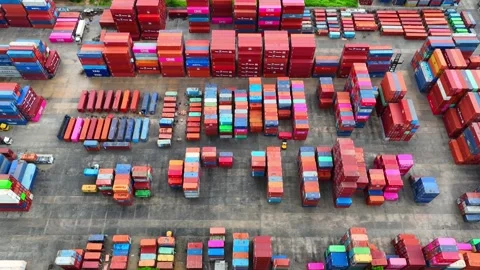 Container yard, a bustling hub of stacked shipping containers. Stockbeeldmateriaal 249728000