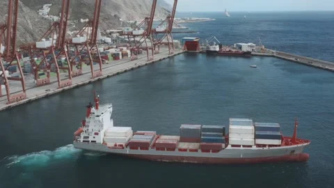 A containerized cargo ship enters the port for unloading Video stock 132053385