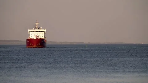 A containerized cargo ship enters the port for unloading. Big container ship Video stock 245438394