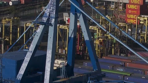 Containers and straddle carriers cranes in foreground Helicopter  telephoto Stock Footage 61436978