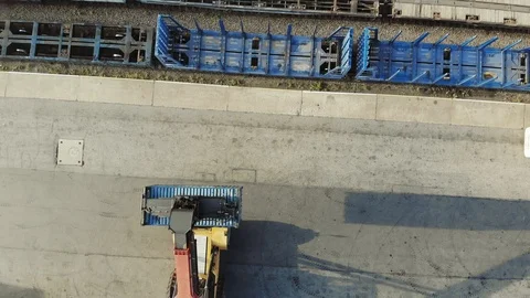 Containers are being lifted on to a block train by means of a transtainer Stock Footage 101229603