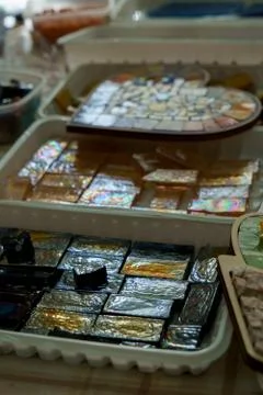 Containers with colored glass elements for mosaic Stock Photos