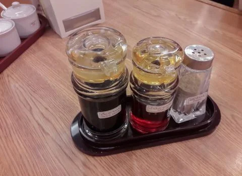 Containers for condiments on the table. Stock Photos