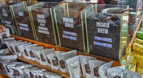Containers of Different Flavored Weasel Coffee Beans Stock Photos