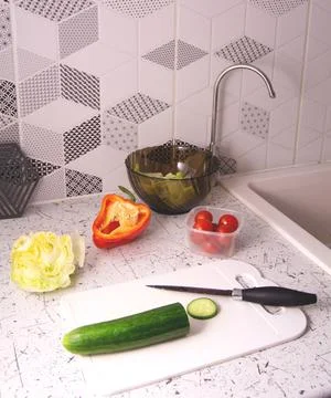 Containers with fresh vegetables on a yellow background Stock Photos