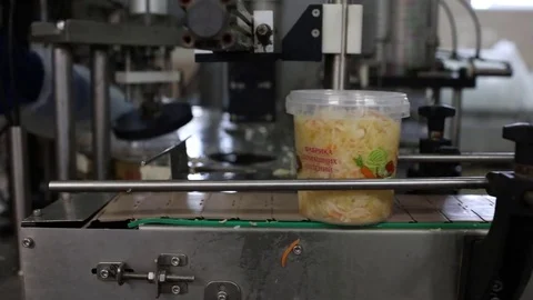 Containers with pickled cabbage on a conveyor Stock Footage 74476257