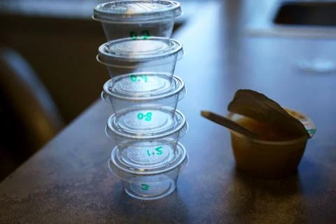 Containers with small incremental amounts of peanuts given to mostly children Foto stock
